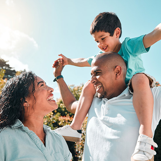 A happy mom and dad with young child