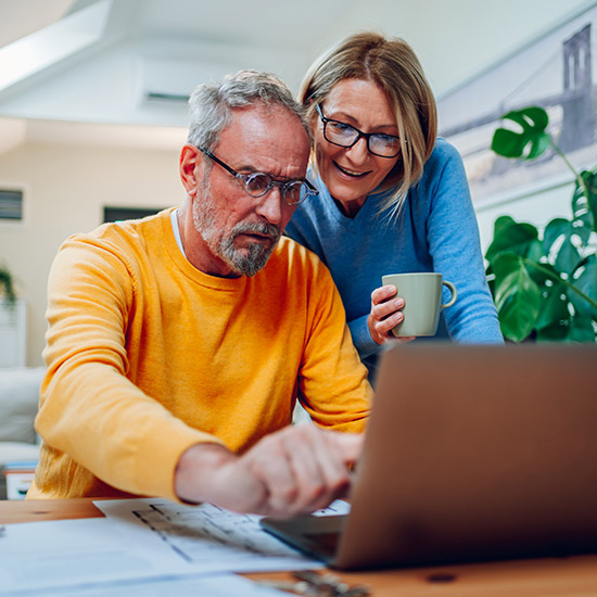 A couple looking at something on a computer screen