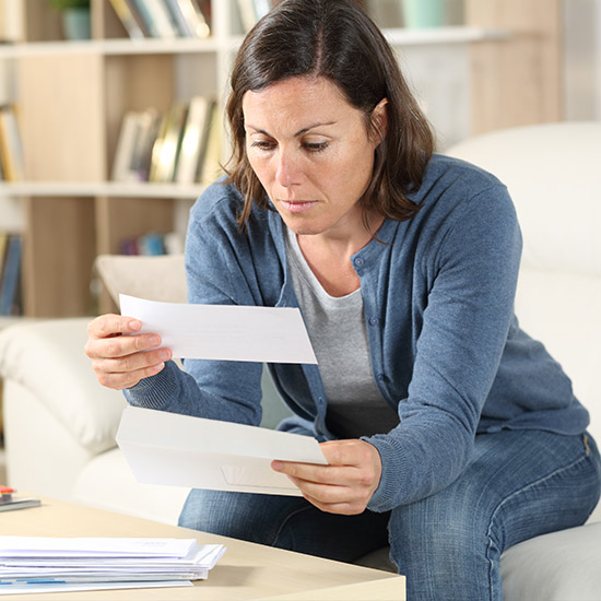 Woman sitting down looking through mail